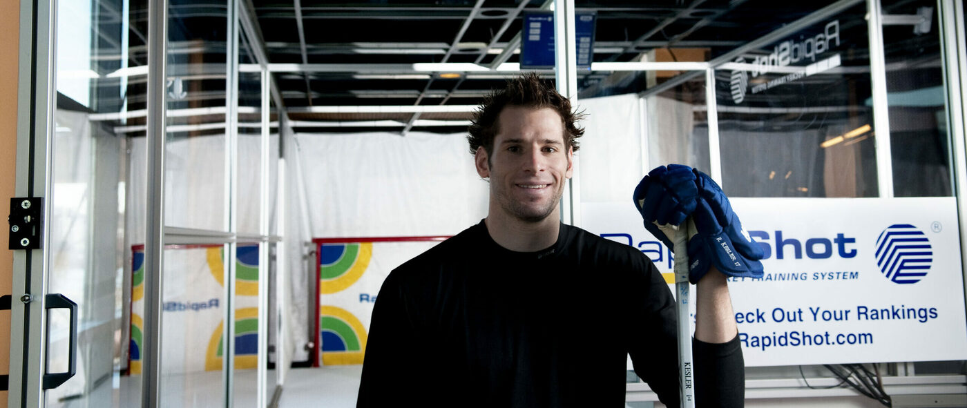 Hockey player posing with the RapidShot Hockey Training System